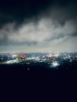 A glowing network of cloud servers interconnected against a twilight city skyline.