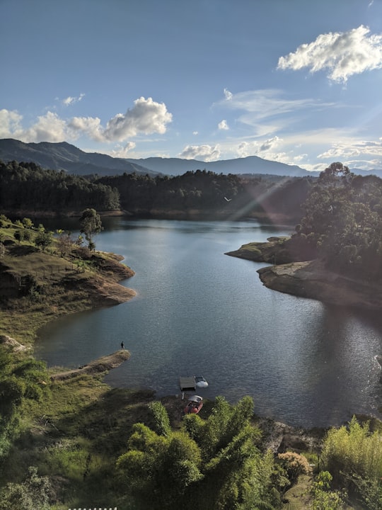 body of water under cloudy sky during daytime in Guatapé Colombia