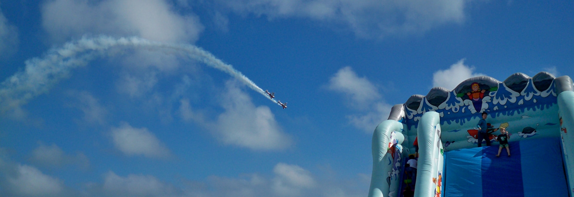 woman wearing yellow long-sleeved dress under white clouds and blue sky during daytime