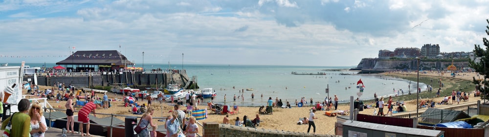 people on beach under blue and white sky