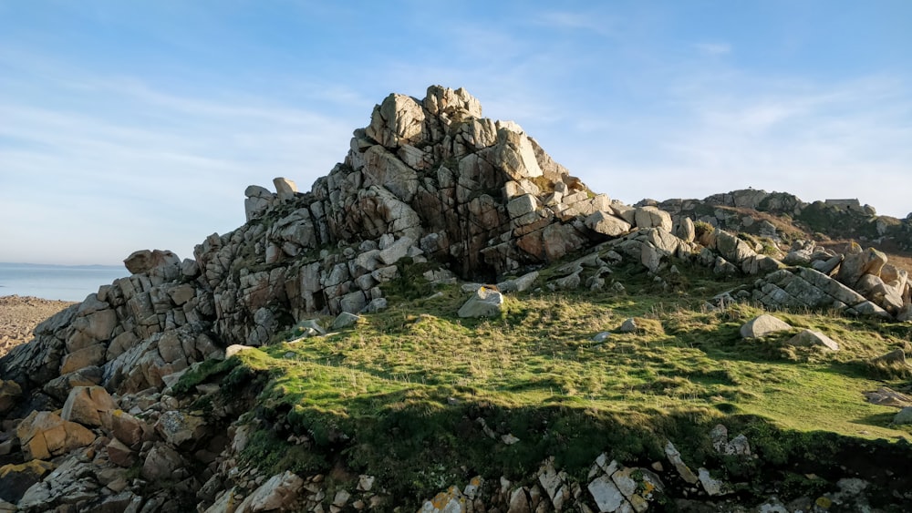 a rocky outcropping with grass and rocks