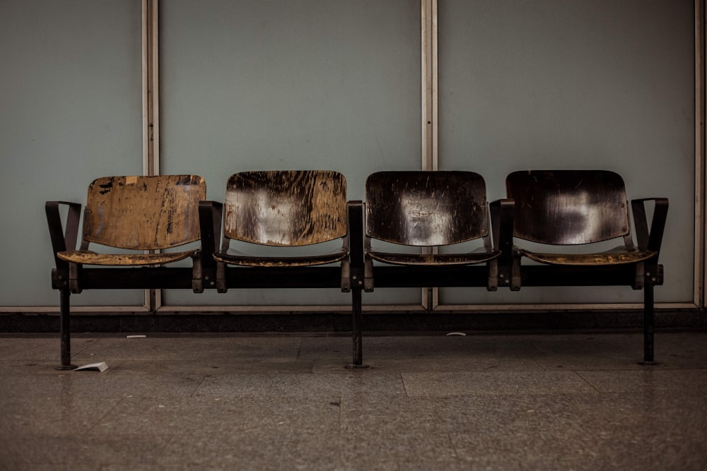 brown and black wooden 4-seat gang chair