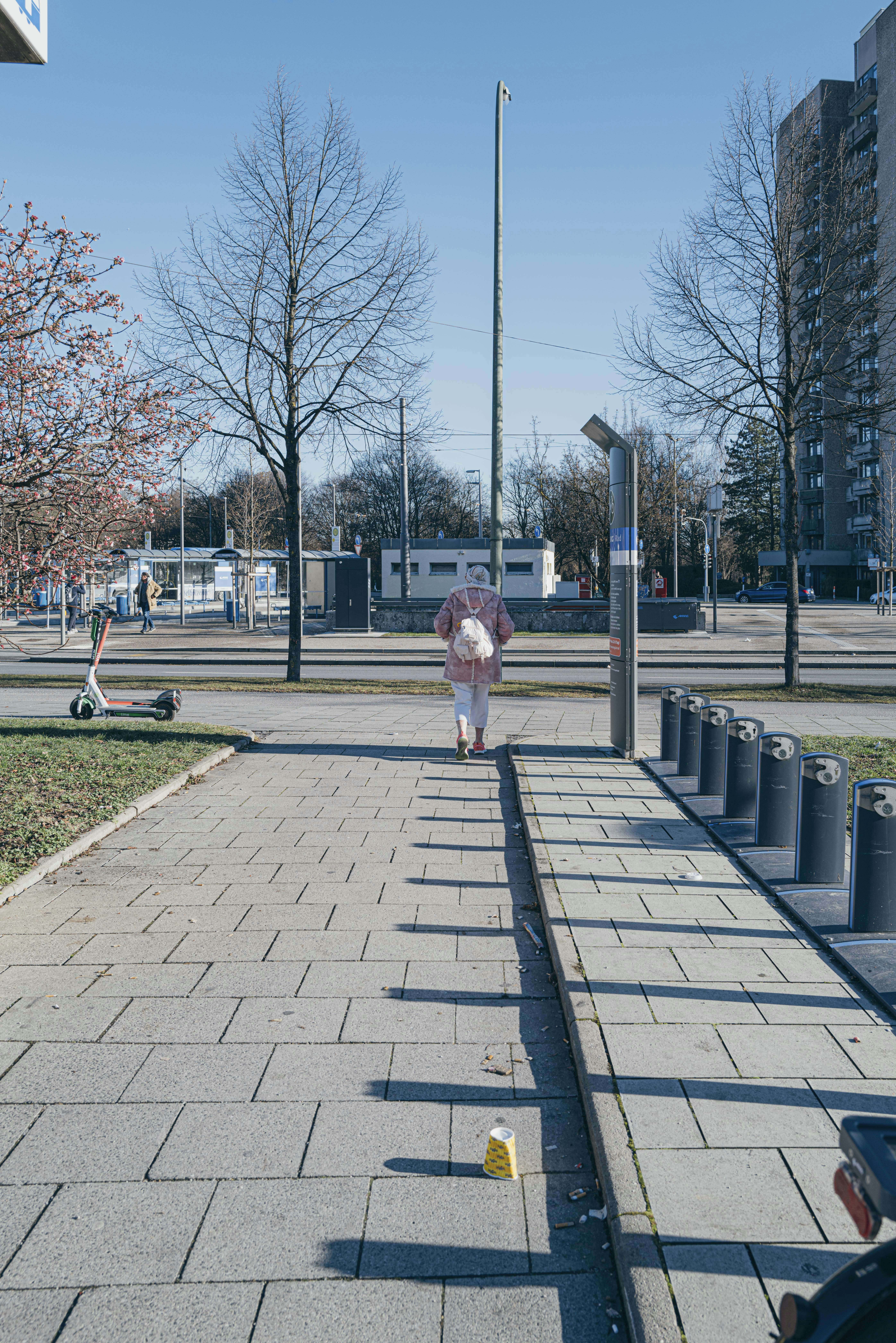 person walking on sidewalk during sunny day