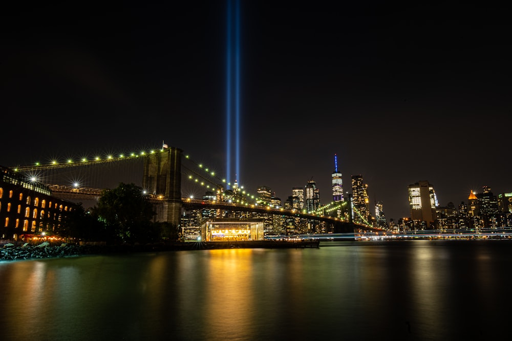 lighted bridge near sea water during night time