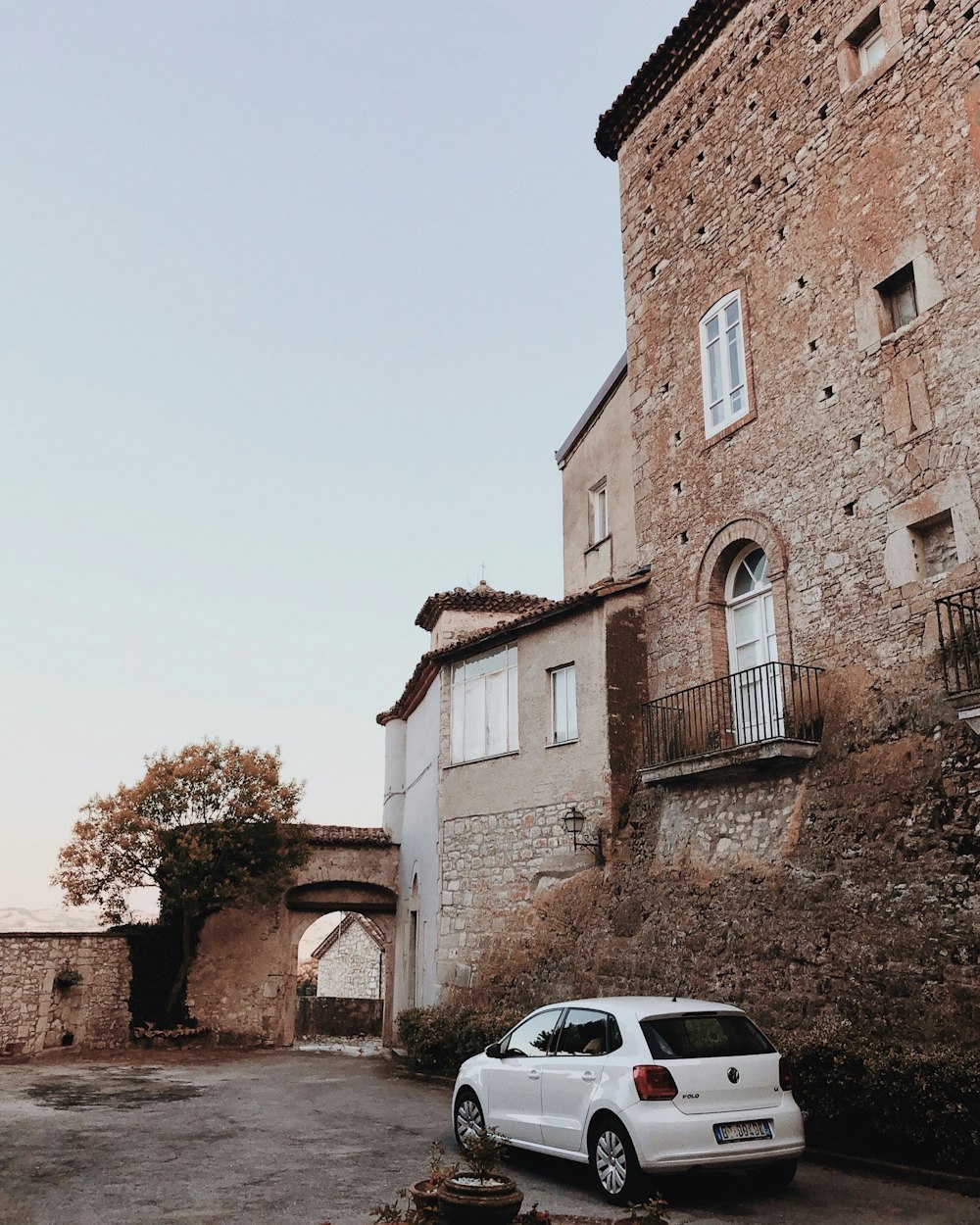 white 3-door hatchback near house