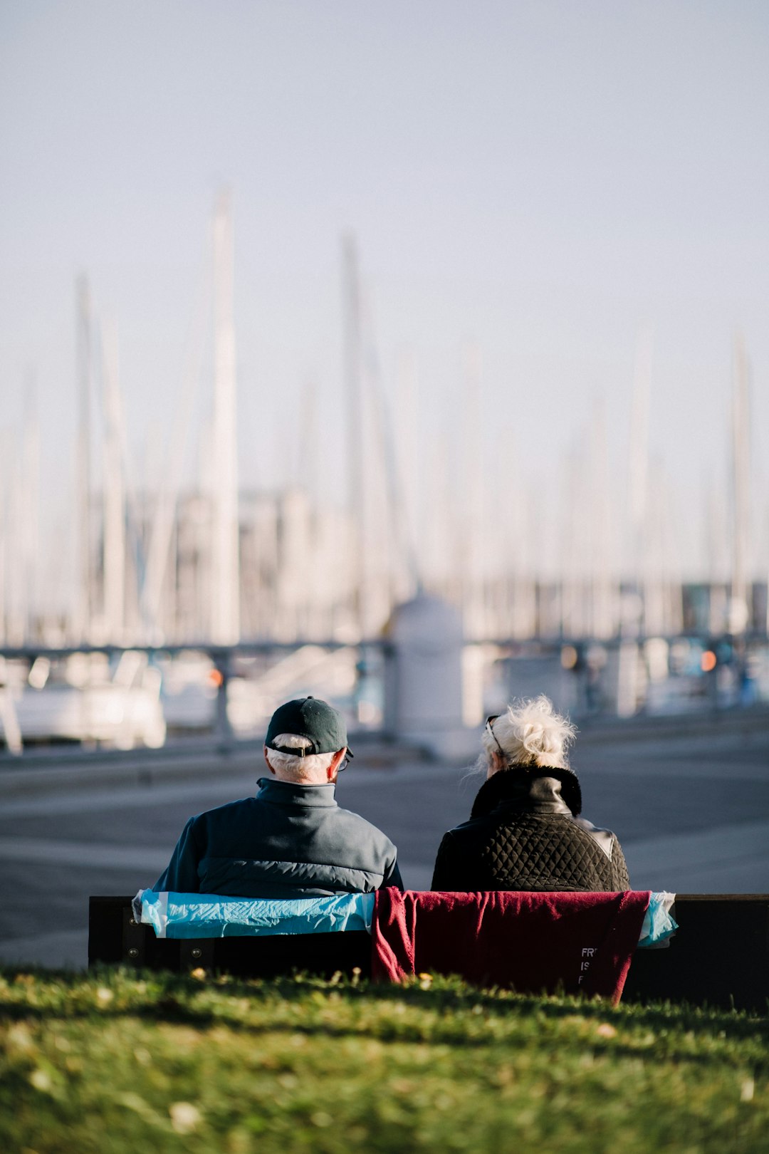 two people sitting on bench during daytime