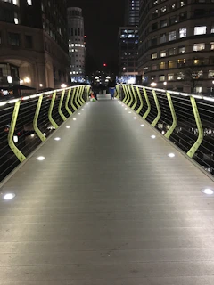 A sleek, modern railway bridge at dusk with glowing city lights in the background, symbolizing advanced transportation engineering.