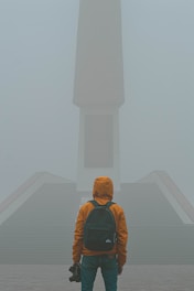man standing in front of cauldron