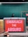 A man wearing a hat and dark clothing walks past a large red sign with the text 'EMBRACE THE ABSURD'. The background consists of a green construction barrier and there are construction materials like bricks and metal wiring on the ground.