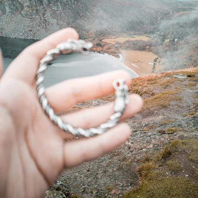 Close-up of a hand-hammered silver bracelet reflecting the rugged textures inspired by Cangshan mountains.