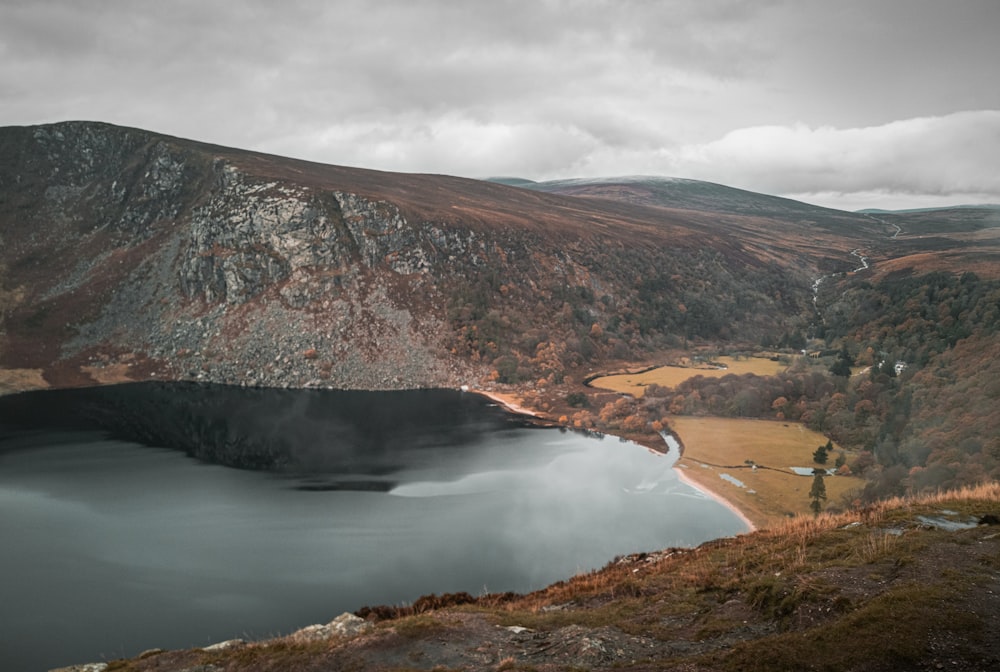 body of water under cloudy sky during daytime