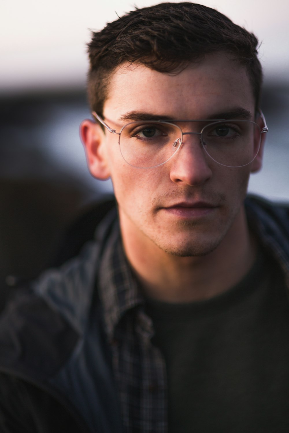 men's gray framed eyeglasses and black jacket