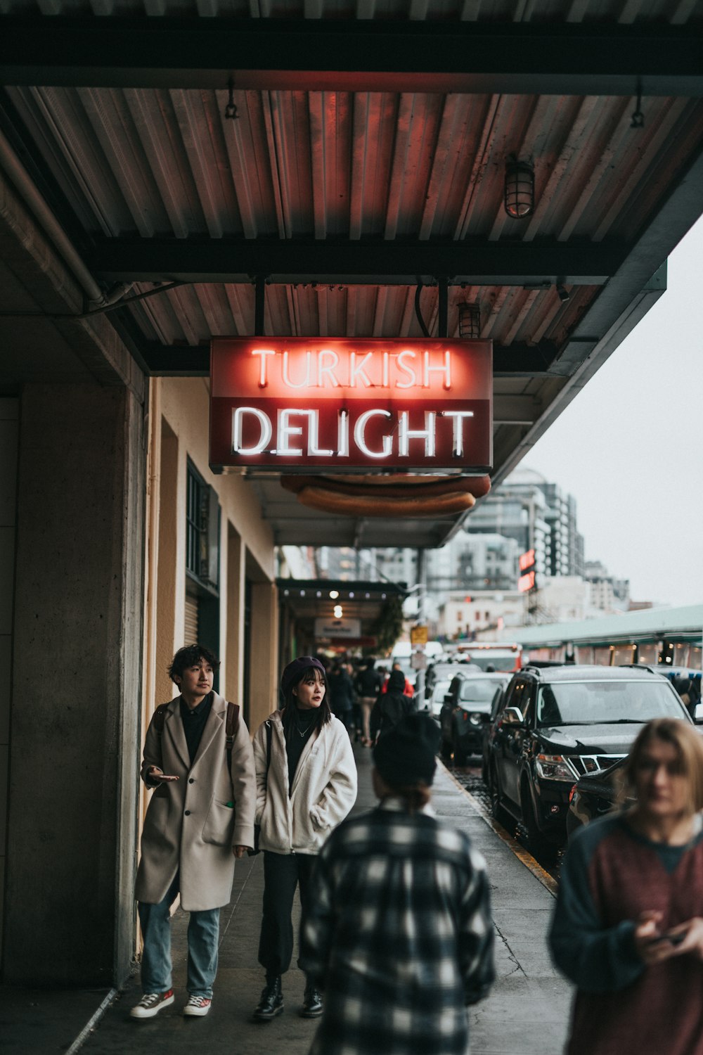 people walking under Turkish Delight sign