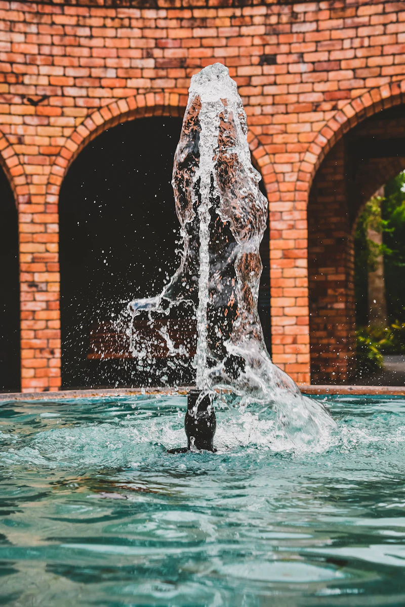 Pool water feature with cascading spillover spa