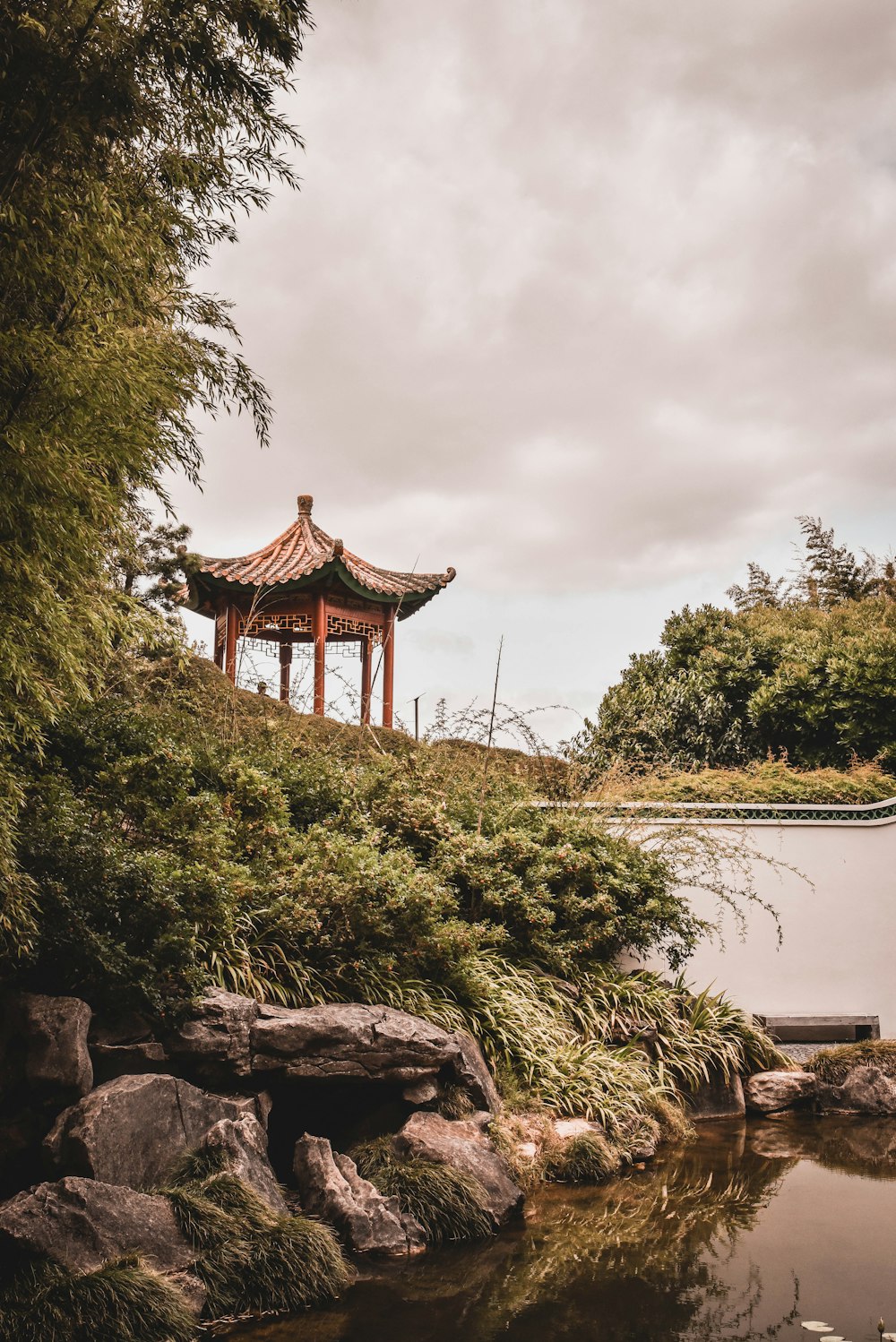 brown pagoda near trees under white sky