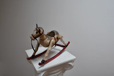 A playful rocking horse made of smooth wood, placed next to a button inviting visitors to get the price.