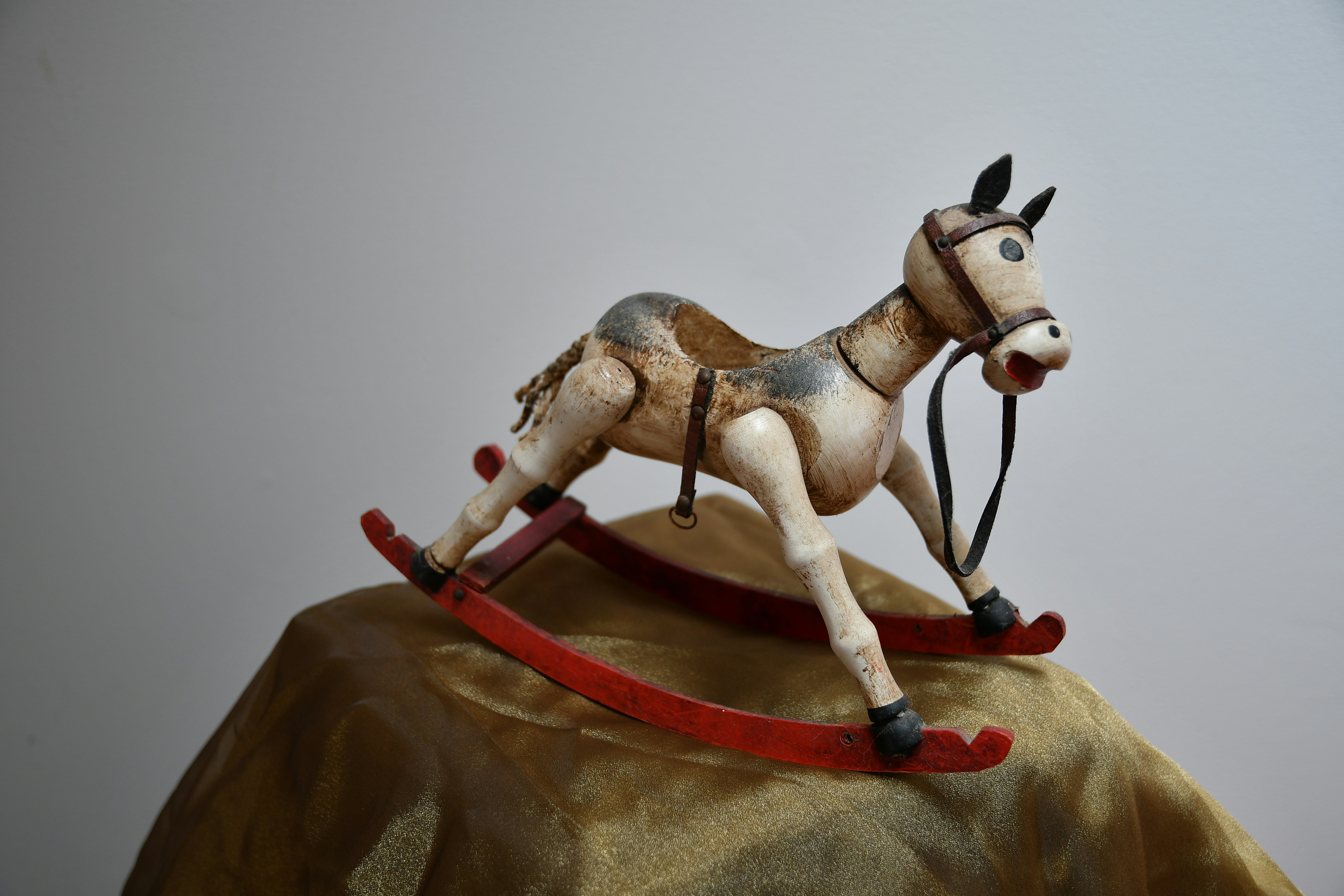 horse rocking toy on brown textile