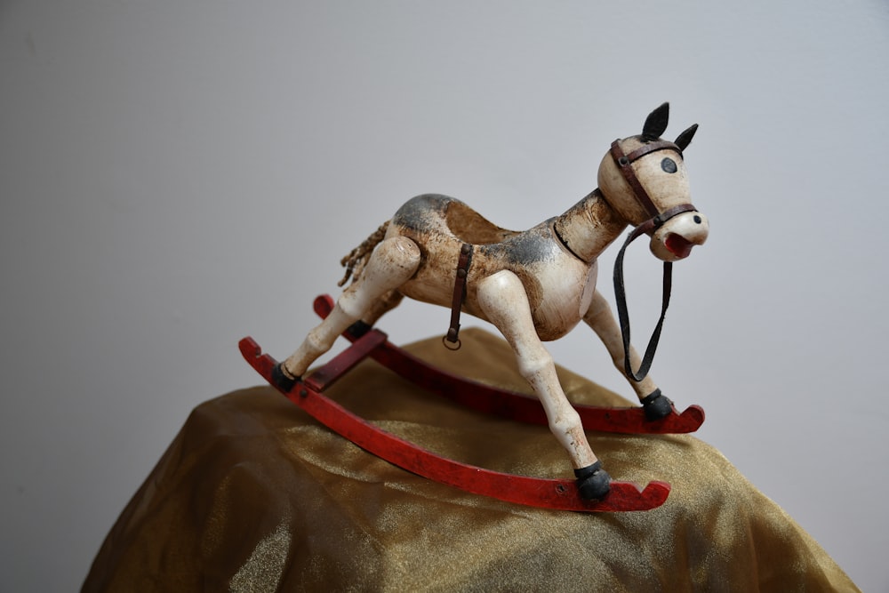 horse rocking toy on brown textile