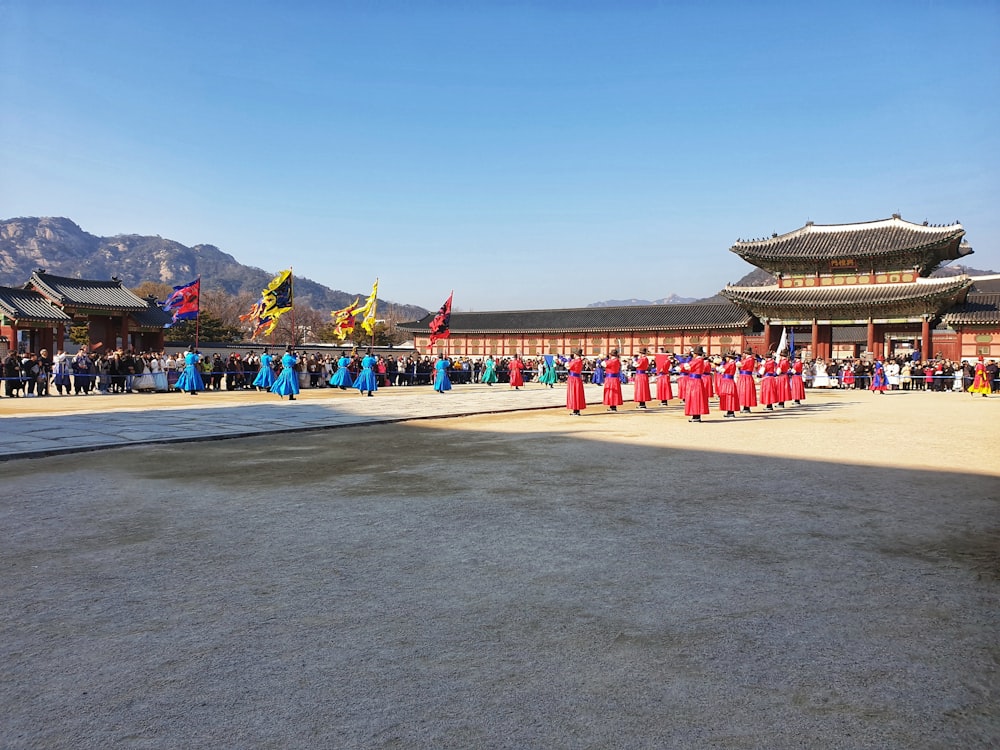 crowd wearing costumes in front of wooden temple
