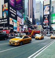 An image of a busy New York City street with TLC-licensed vehicles navigating through traffic.