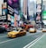 A bustling urban street scene with several iconic yellow taxis driving down a busy avenue. Bright, colorful advertisements and large digital billboards cover the facades of tall buildings. A double-decker tour bus and numerous pedestrians are visible, conveying a sense of vibrant city life.