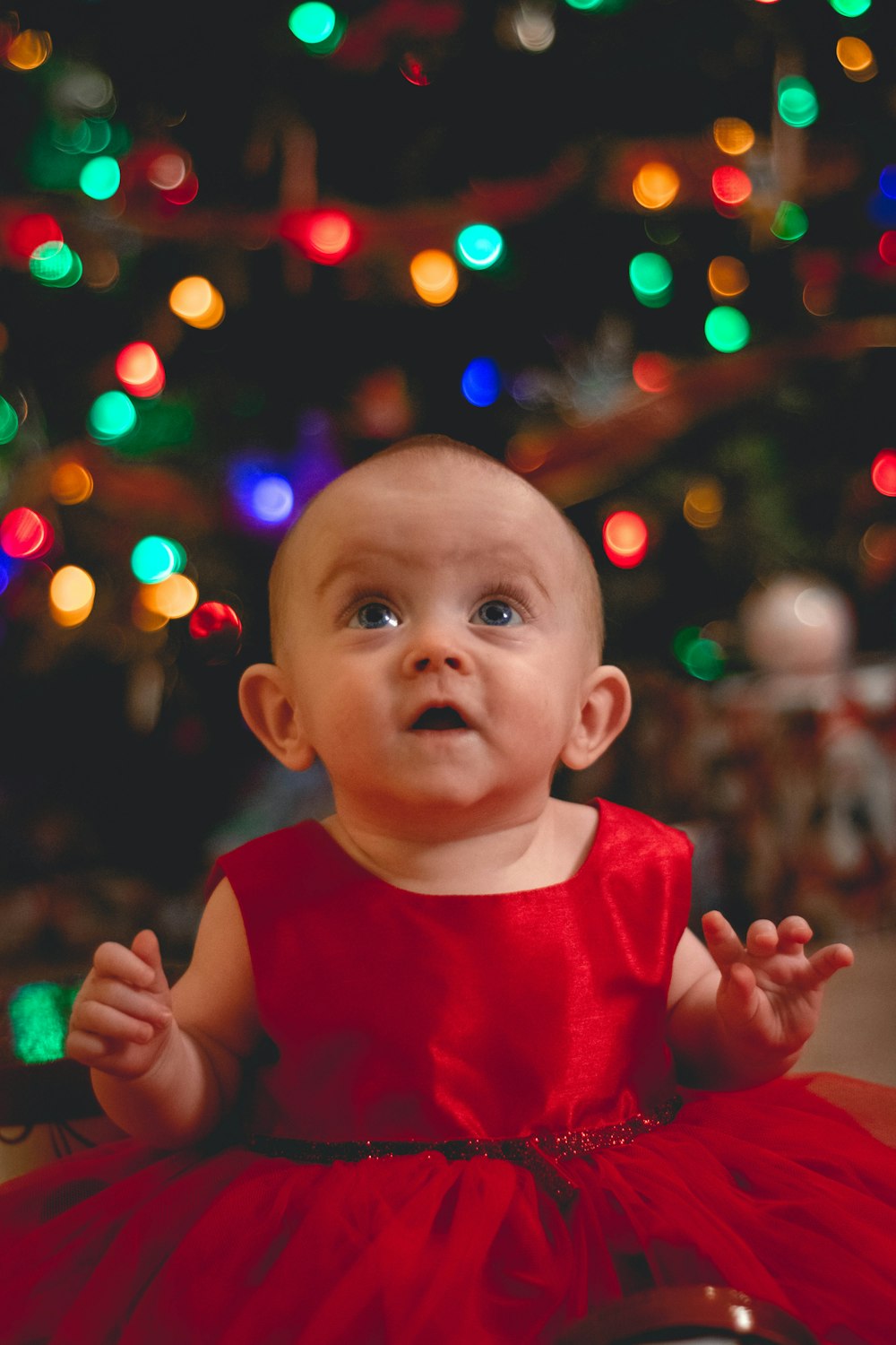 child looking up in red dress