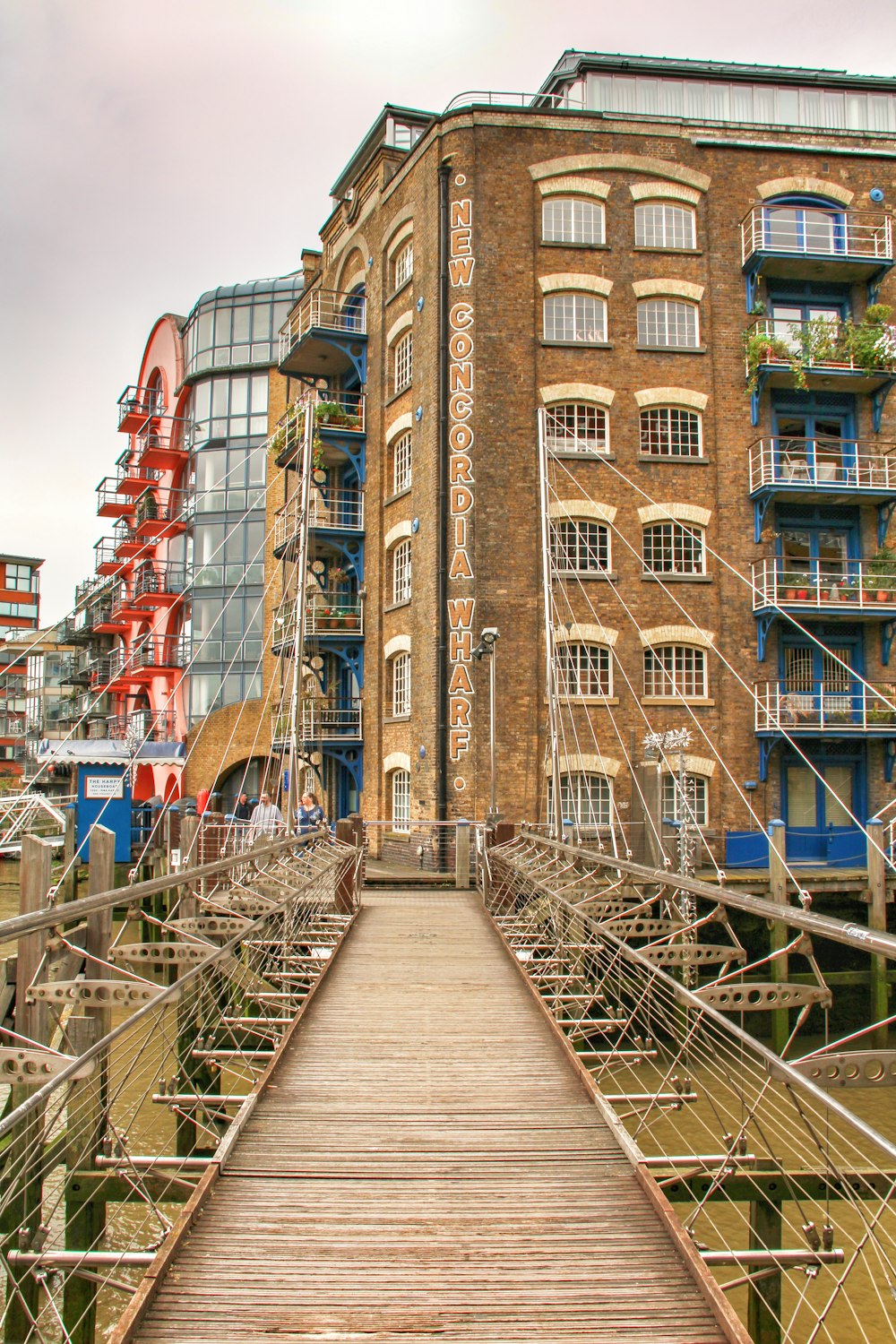 brown wooden footbridge near high-rise buildings