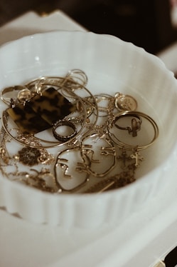gold-colored jewelry lot in container