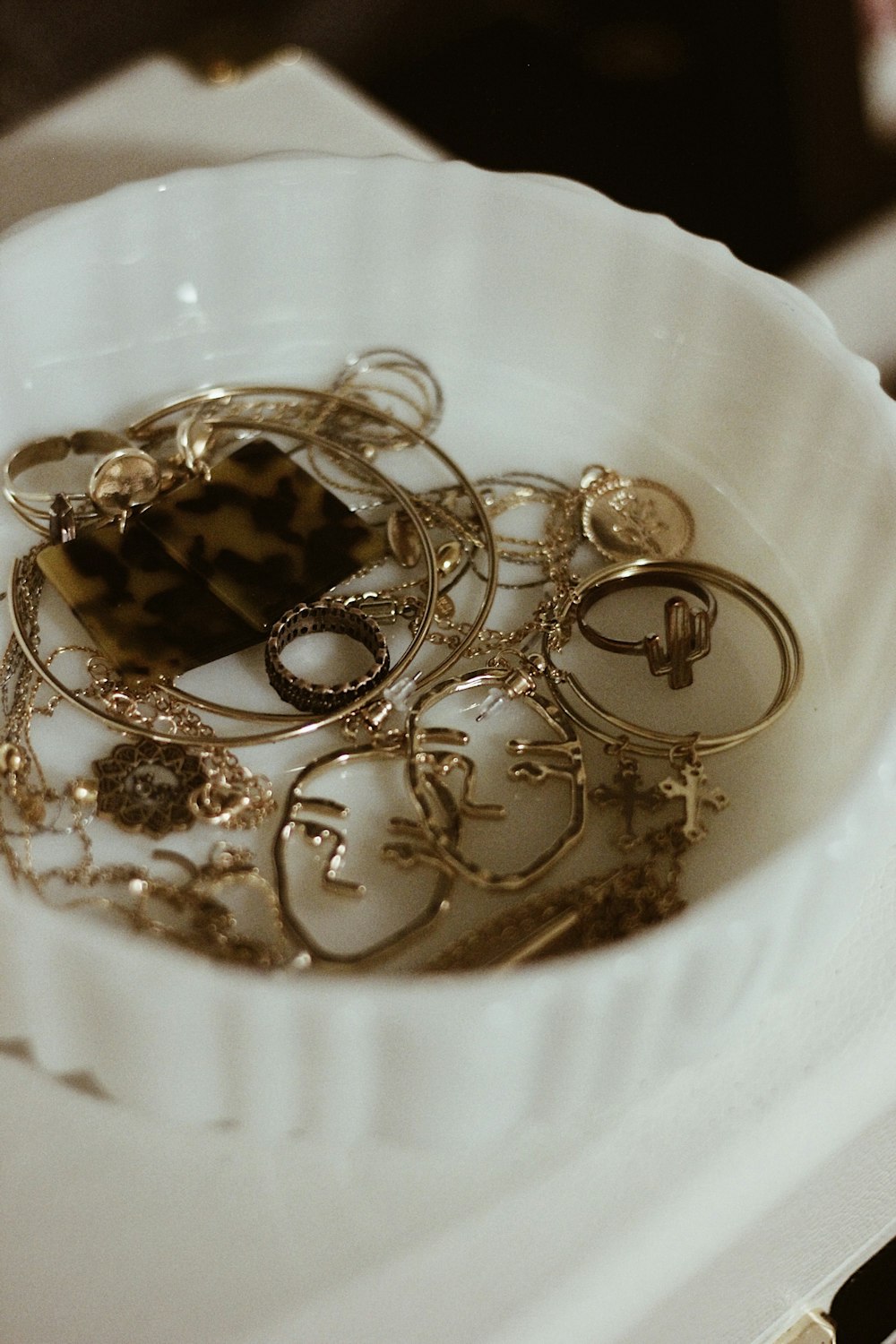 gold-colored jewelry lot in container