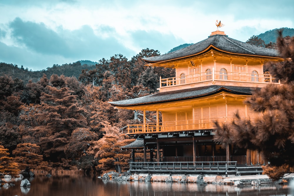 view of pagoda by water and trees