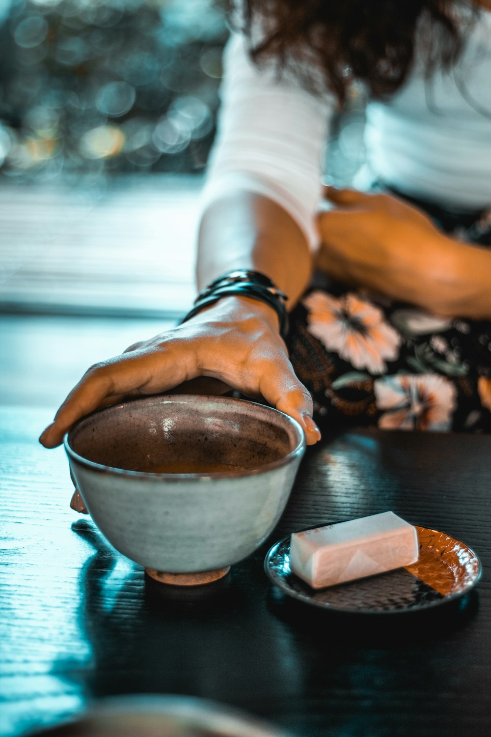 selective focus photography of person holding gray bowl