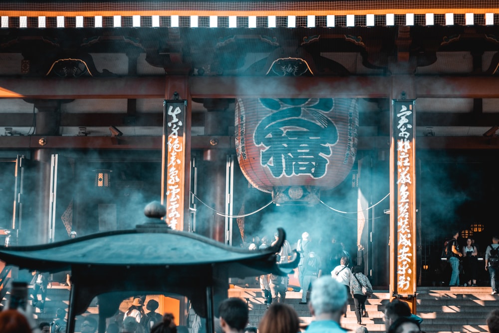 selective focus photography of people under Chinese lantern