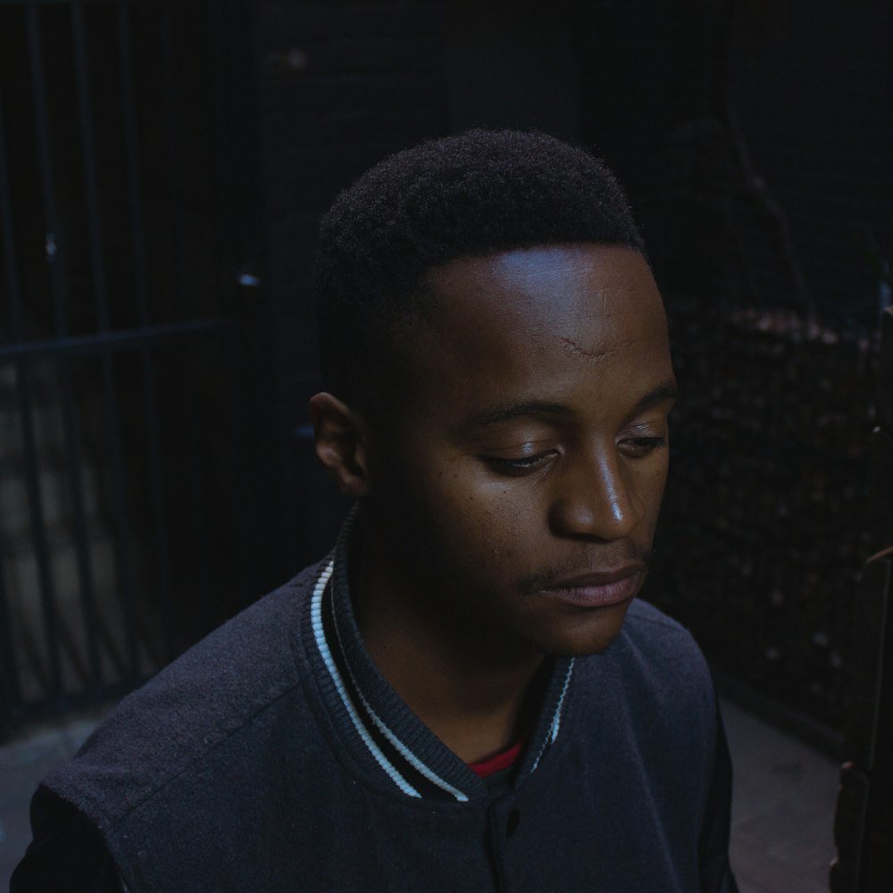 selective focus photography of man wearing gray button-up jacket