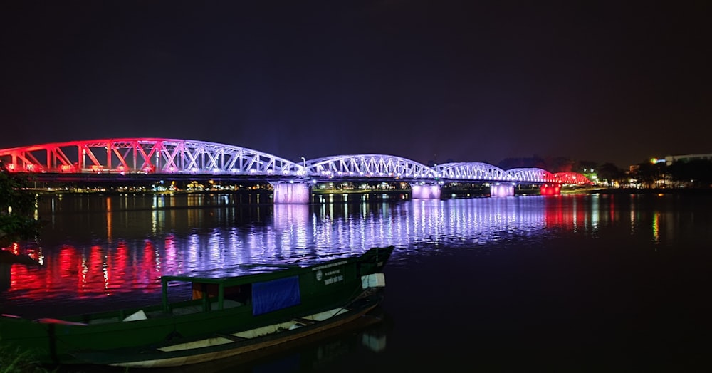 metal bridge with white and red lights that is turned on at nighttime