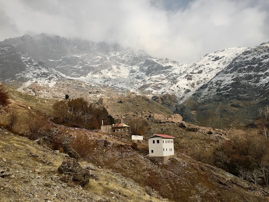 white concrete building on mountain under cloudy sky during daytime in Darband Iran