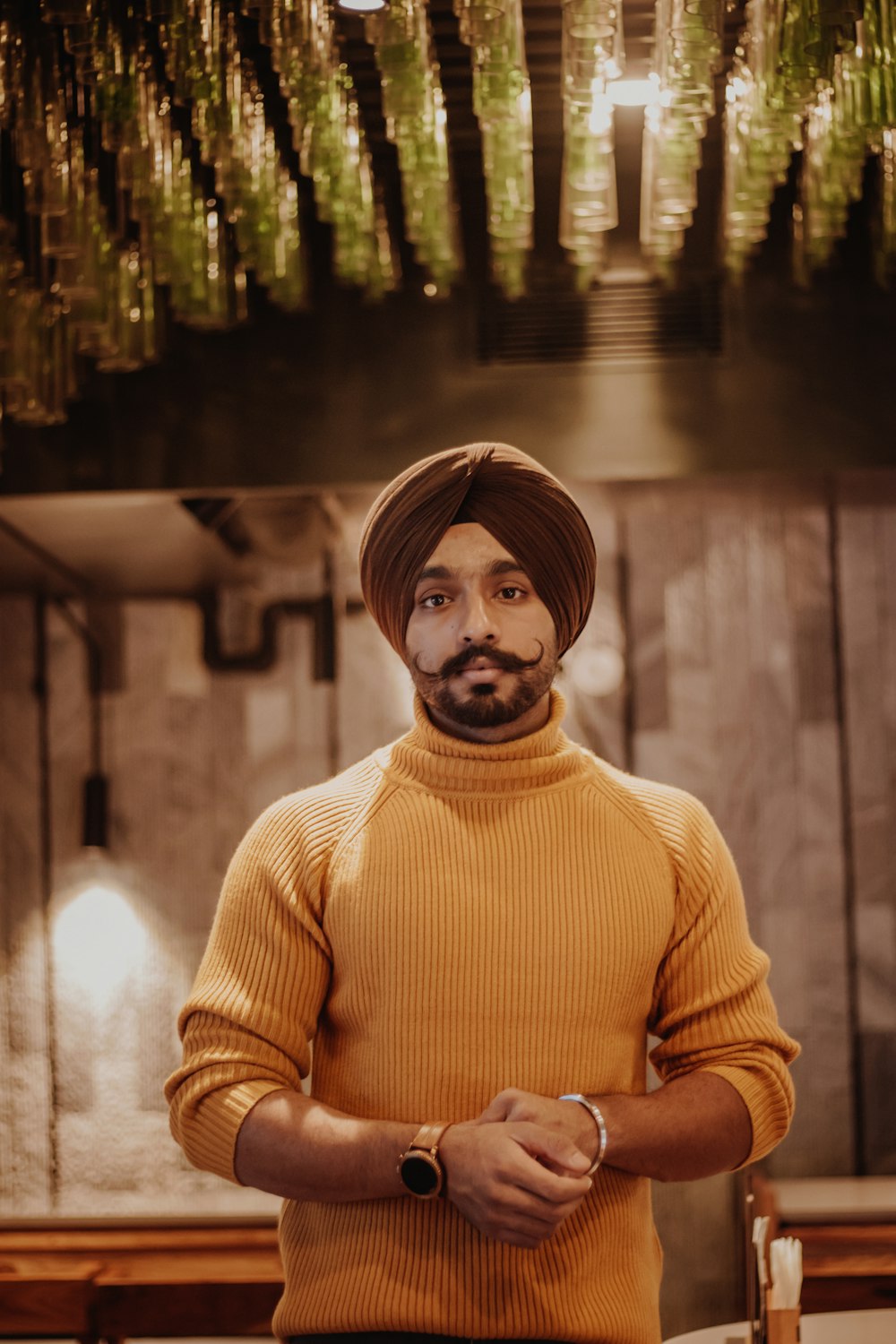 selective focus photography of standing man wearing turban