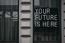 a window with a sign that says your future is here