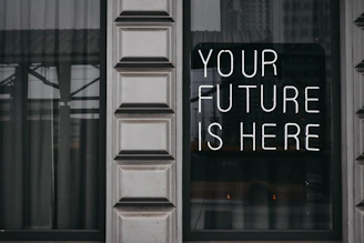 a window with a sign that says your future is here