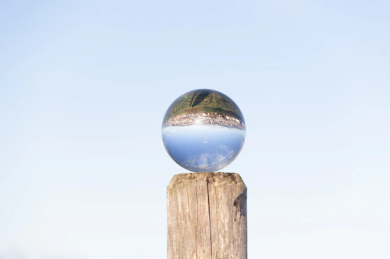 A serene crystal ball glowing softly on a wooden table.