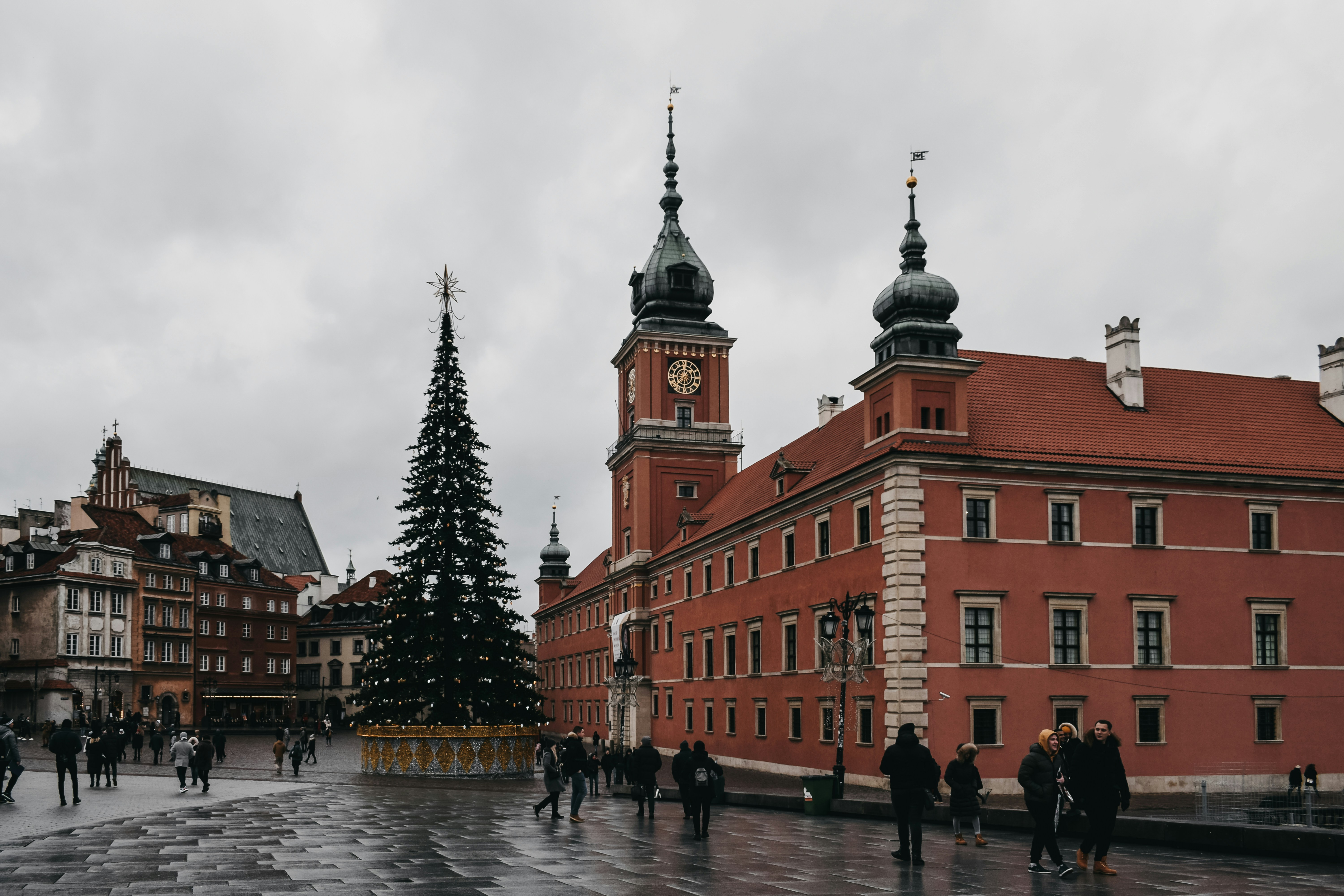 Brown building near Warsaw Royal Castle decorated with Christmas lights