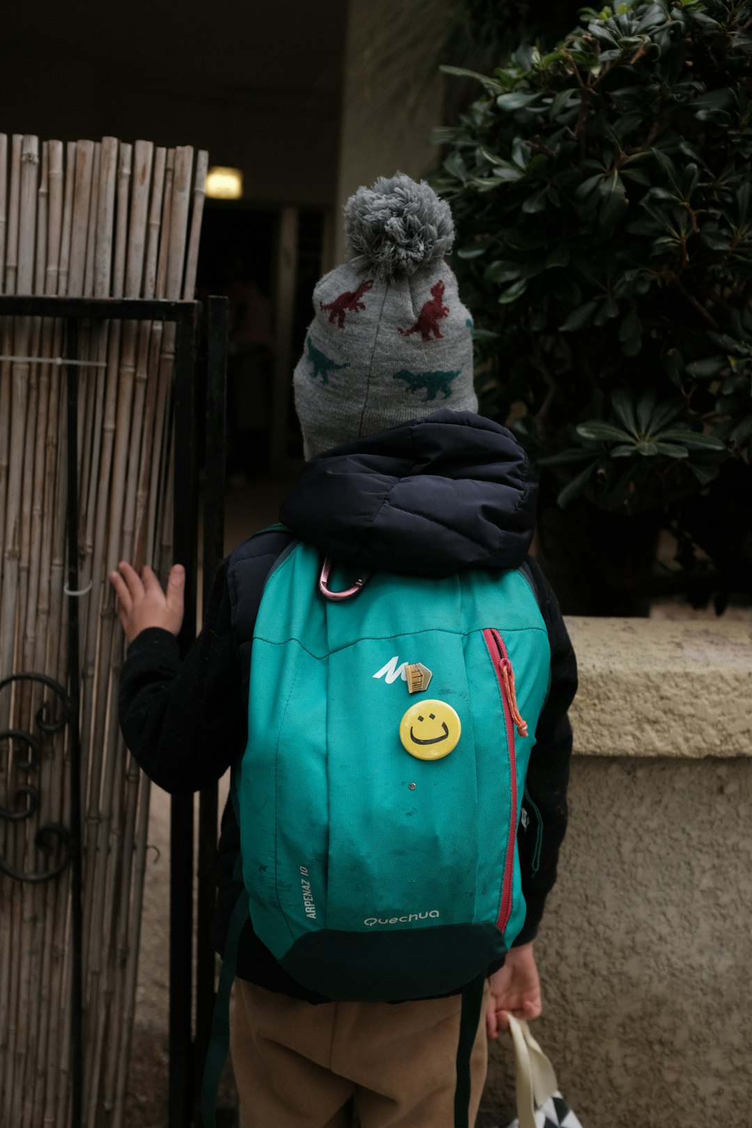 boy wearing green backpack