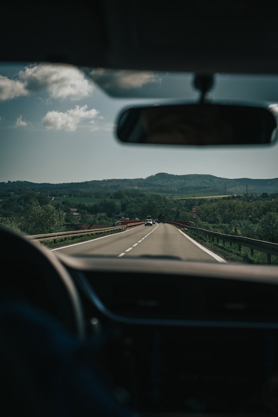 person riding vehicle on road during daytime in Polanica-Zdrój Poland