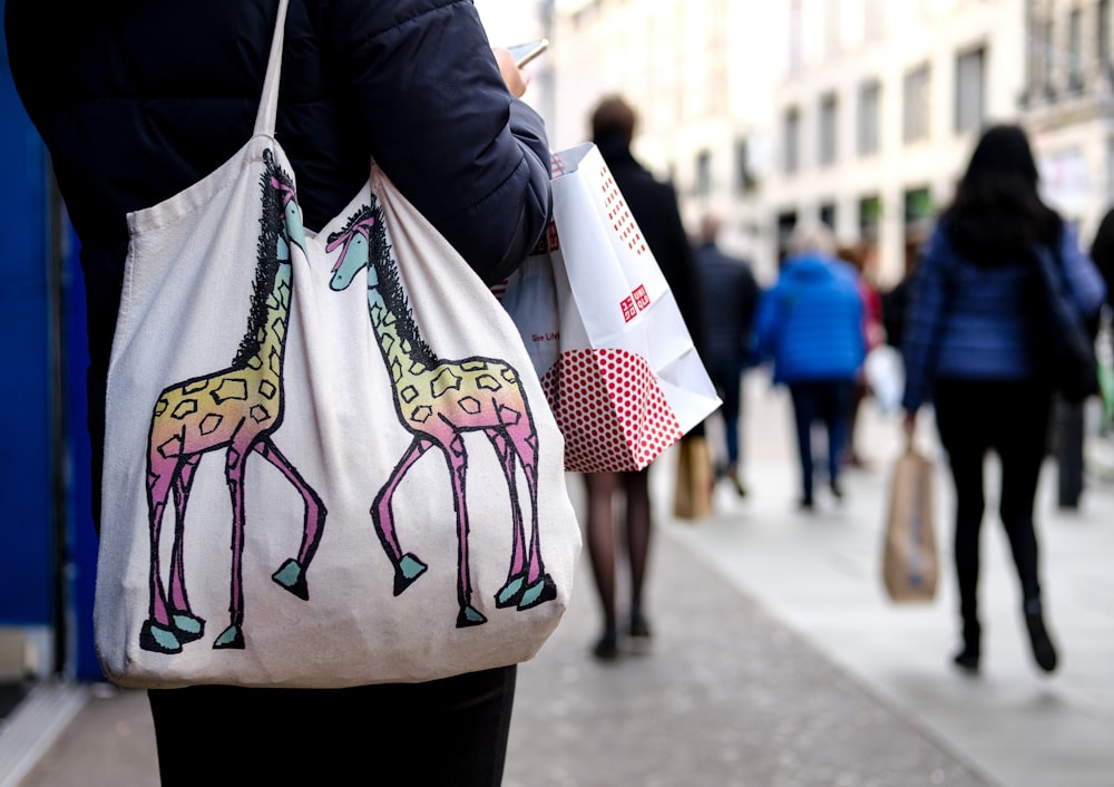 person carrying a white shoulder bag