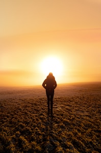 silhouette photography of unknown person standing outdoors