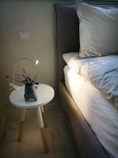 gray vase on top of white chair
