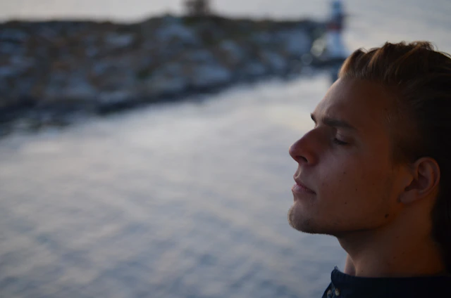 A serene portrait of Jogender Singh meditating outdoors, radiating calm and focus.