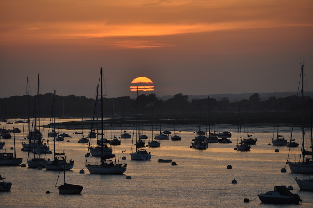 boats on sea during sunset