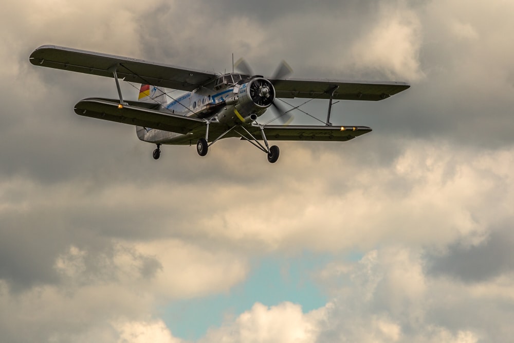 gray biplane flying