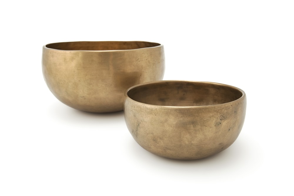 two gold-colored bowls