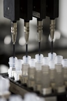 An automated filling machine precisely dispensing liquids into containers.